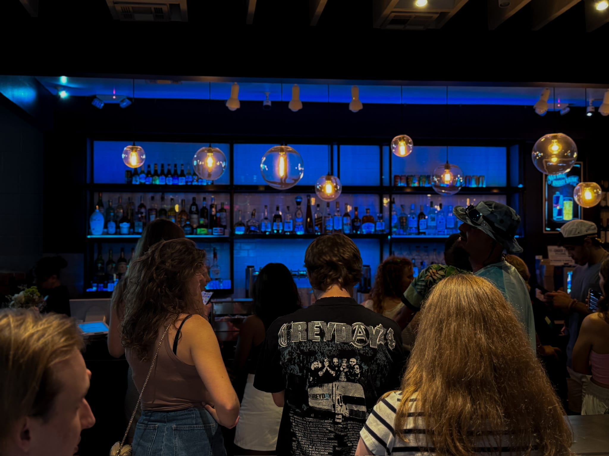Birthday party celebration at Botanic Beer Garden in Houston with guests enjoying craft cocktails in an outdoor garden setting.