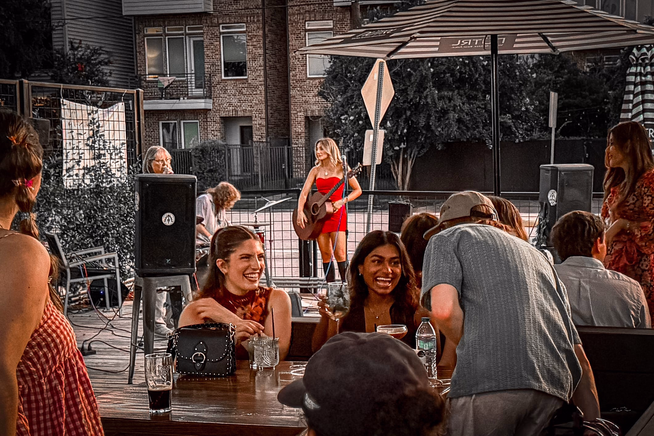 Outdoor baby shower at Botanic Beer Garden in Houston with floral decorations, guests celebrating, and garden-style seating.
