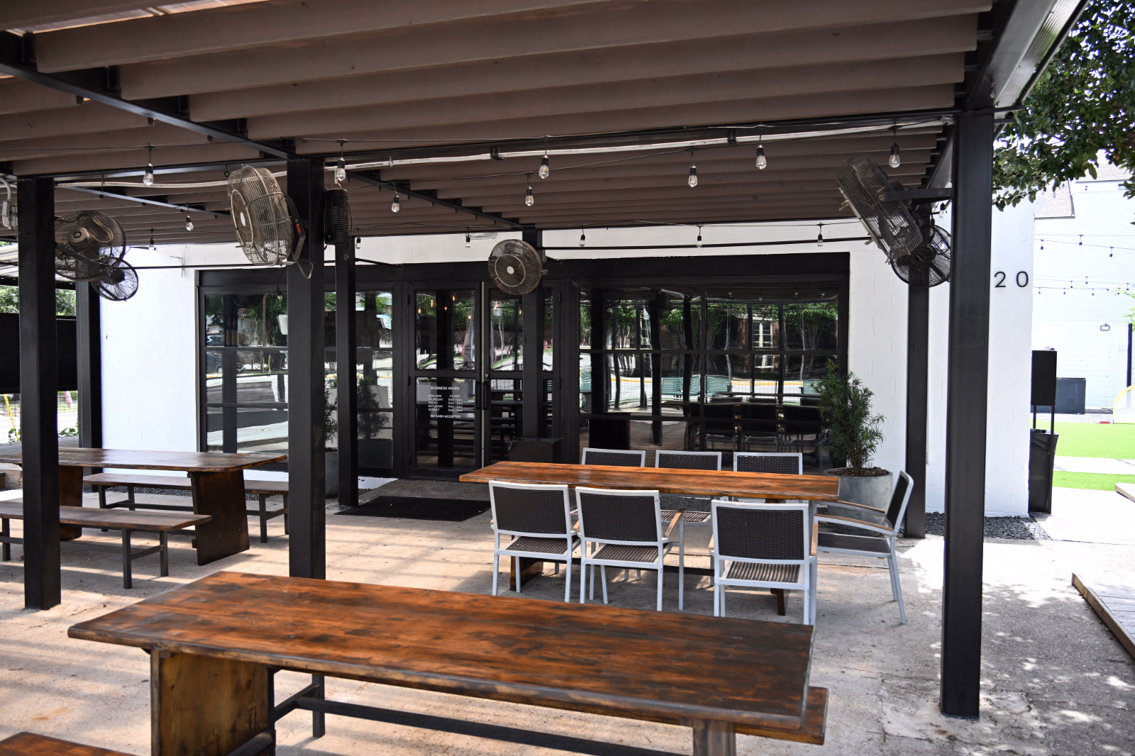 Covered Patio Tables at Botanic Beer Garden Large covered patio at Botanic Beer Garden in The Heights with shared tables and outdoor seating