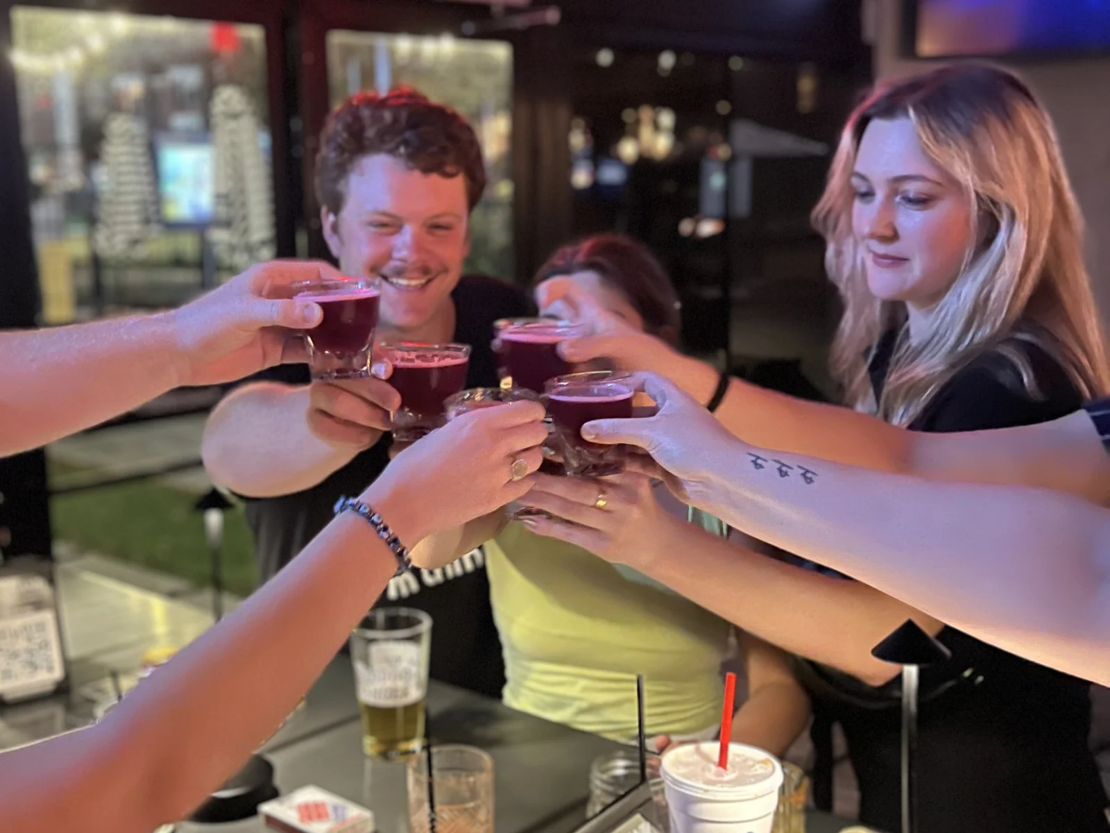 Guest enjoying a night out at Botanic Beer Garden in The Heights Houston with cocktails and patio seating