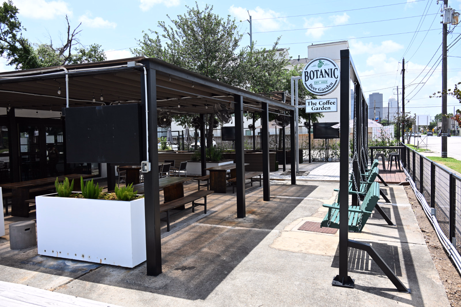 Street Side Patio at Botanic Beer Garden Street-side patio at Botanic Beer Garden in The Heights Houston with outdoor seating and signage