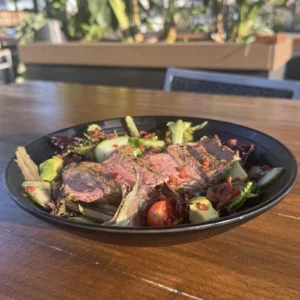 Chimichurri steak salad with avocado, cherry tomatoes, cucumbers and bacon at Botanic Beer Garden in the Heights Houston