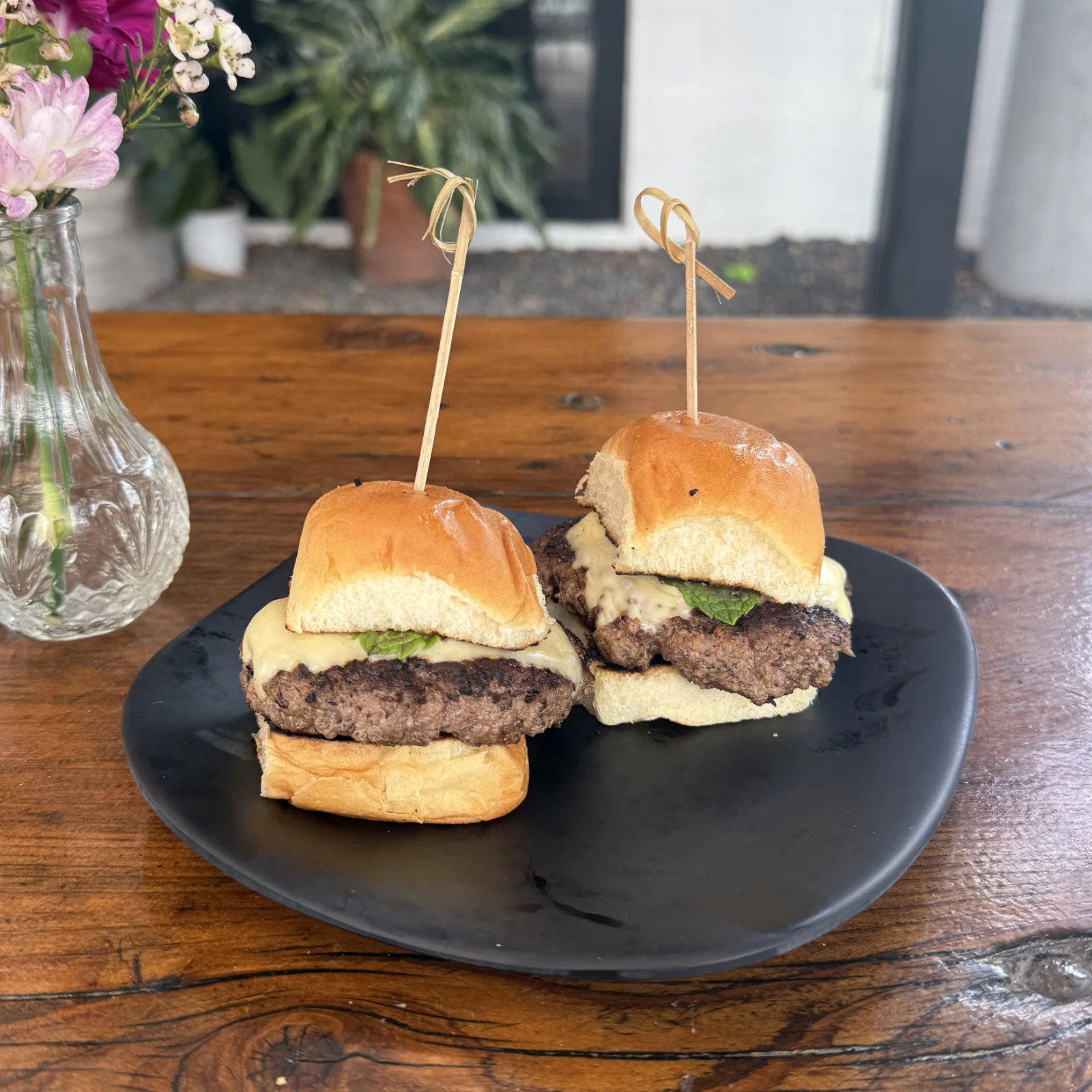 Burger sliders in the Heights with handmade beef patties, Swiss cheese, and Hawaiian buns at Botanic Beer Garden