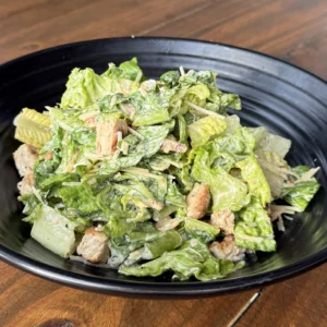 Chicken Caesar salad in the Heights with grilled chicken, romaine, parmesan, and Caesar dressing at Botanic Beer Garden